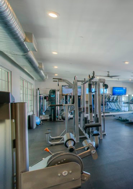 Exposed spiral HVAC ductwork visible in a modern gym, installed by Sun Devil Heating & Cooling INC in Peoria, AZ.