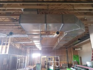 Exposed HVAC ductwork installation in a building under construction by After Hours Heating & Air Conditioning LLC in Chesapeake, VA.