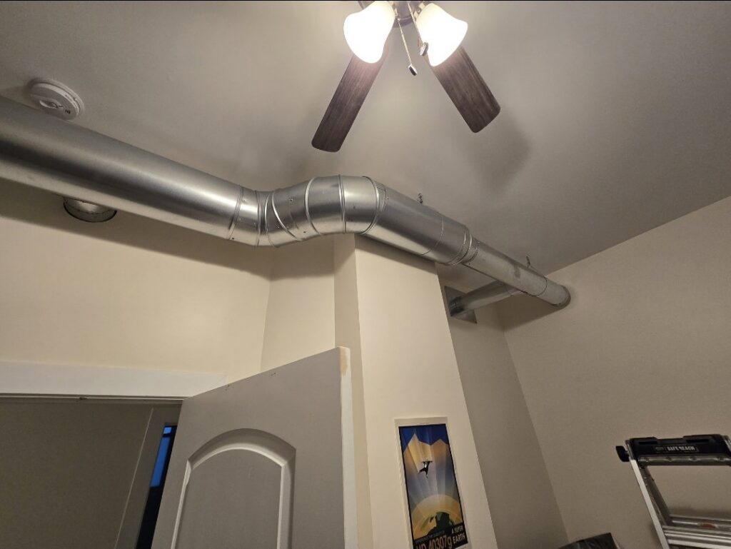 Newly installed exposed HVAC ductwork in a room by Cosmic HVAC in Chicago, IL.