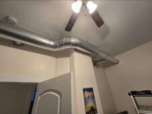 Newly installed exposed HVAC ductwork in a room by Cosmic HVAC in Chicago, IL.