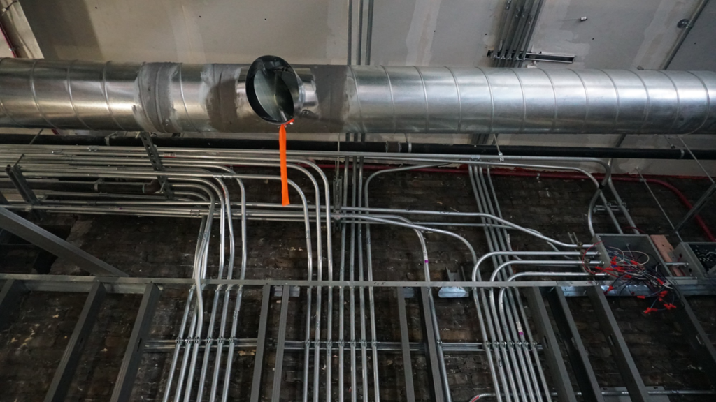 Exposed HVAC ductwork installation in a commercial building by Giant HVAC in Chicago, IL