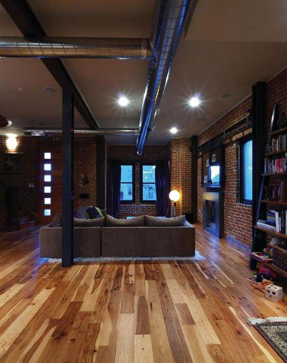 Exposed HVAC ductwork integrated into the modern industrial design of a living space by J & J Heating and Cooling, Inc. in Lancaster, PA.