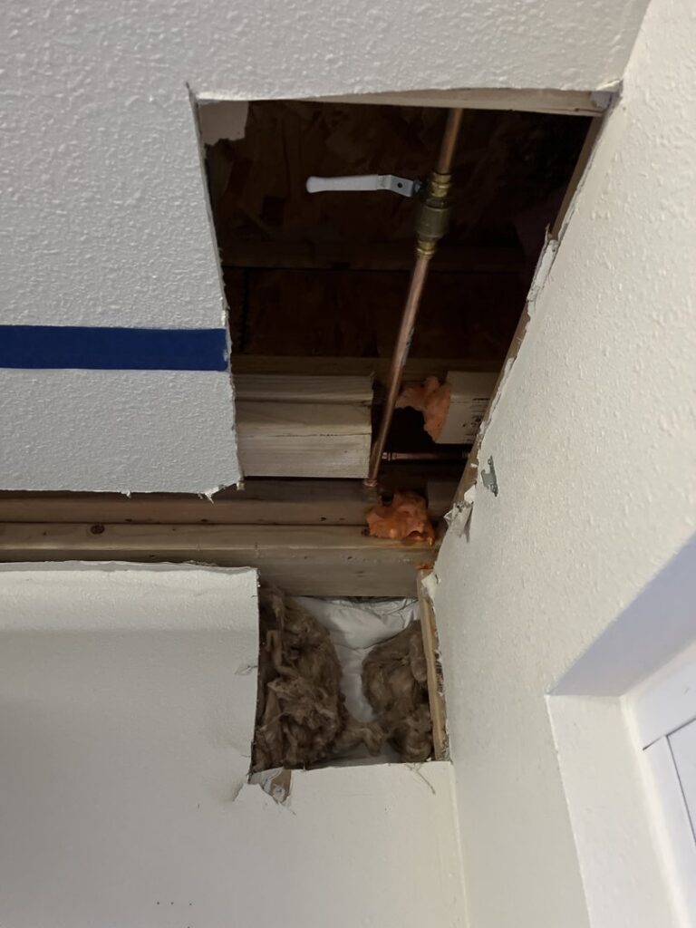 Exposed HVAC piping and insulation within a ceiling or wall opening by Service Experts Denver in Westminster, CO