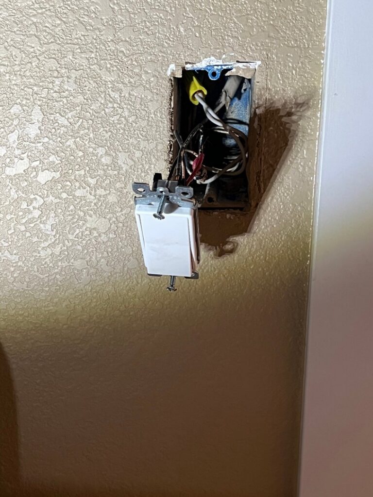 Exposed light switch wiring inside a wall box, showing ongoing electrical work by AC-DC Electric in Severance, CO.