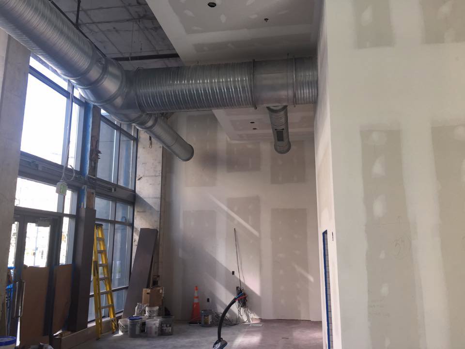 Exposed spiral ductwork installation in a commercial building under construction by JDL HVAC Services, LLC in Laurel, MD.