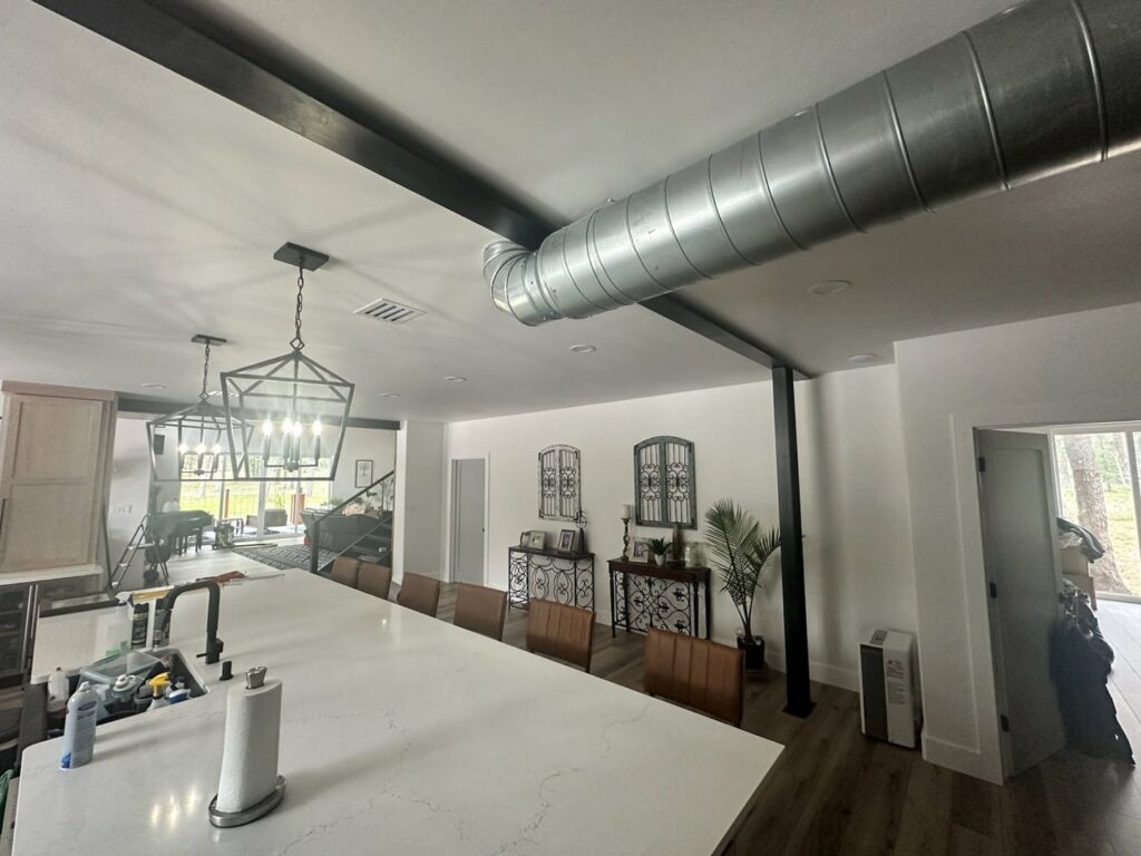 Exposed spiral ductwork installed in a modern interior space by Competition A/C & Heat, LLC in Corpus Christi, TX