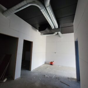 Modern exposed spiral HVAC ductwork installed in a room under construction by Montefusco HVAC in Peoria, IL