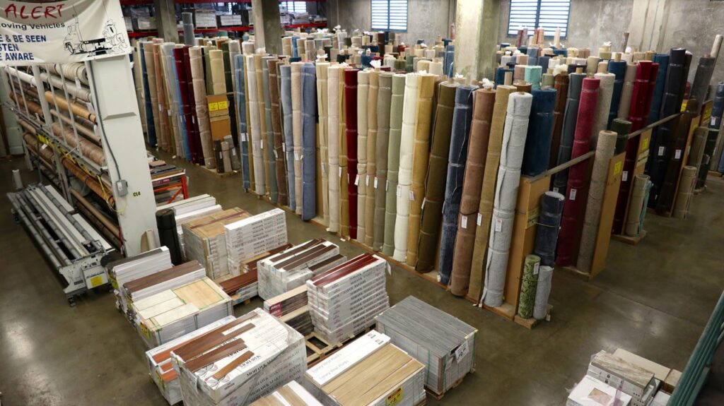 Extensive inventory of carpet rolls and other flooring materials at Georgia Floors Direct in Tallahassee, FL