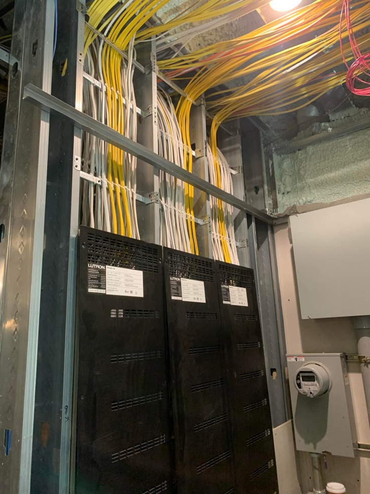 Extensive electrical wiring installation with numerous cables and panels in a commercial space by MDMartin Electrical LLC in Philadelphia, PA.
