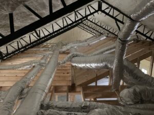 Extensive HVAC ductwork installed in an attic space by Symbiont Services in Englewood, FL.