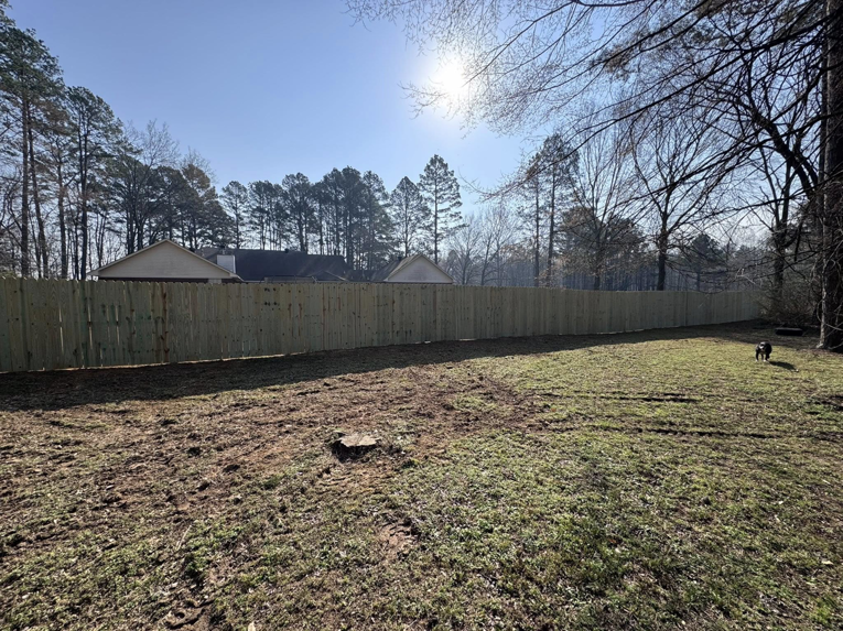 An extensive new wood privacy fence installed in a spacious backyard by Mayan Fence & Outdoor LLC in Phoenix, AZ.