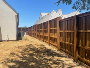 An extensive wood fence line installed along a property boundary by 3M Custom Fence in Lewisville, TX.