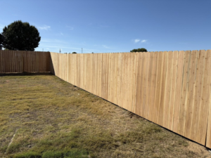 An extensive new wood privacy fence installation in a residential area by McDaniel Quality Fencing LLC in Muldrow, OK.