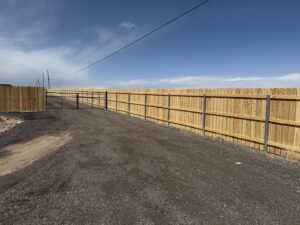 An extensive wooden privacy fence with a gate installed by Pueblo Fence Co in Pueblo West, CO.