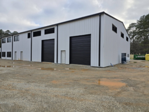 Exterior of a commercial building featuring newly installed black garage doors by Coles Garage Door Service, LLC in West Columbia, SC.