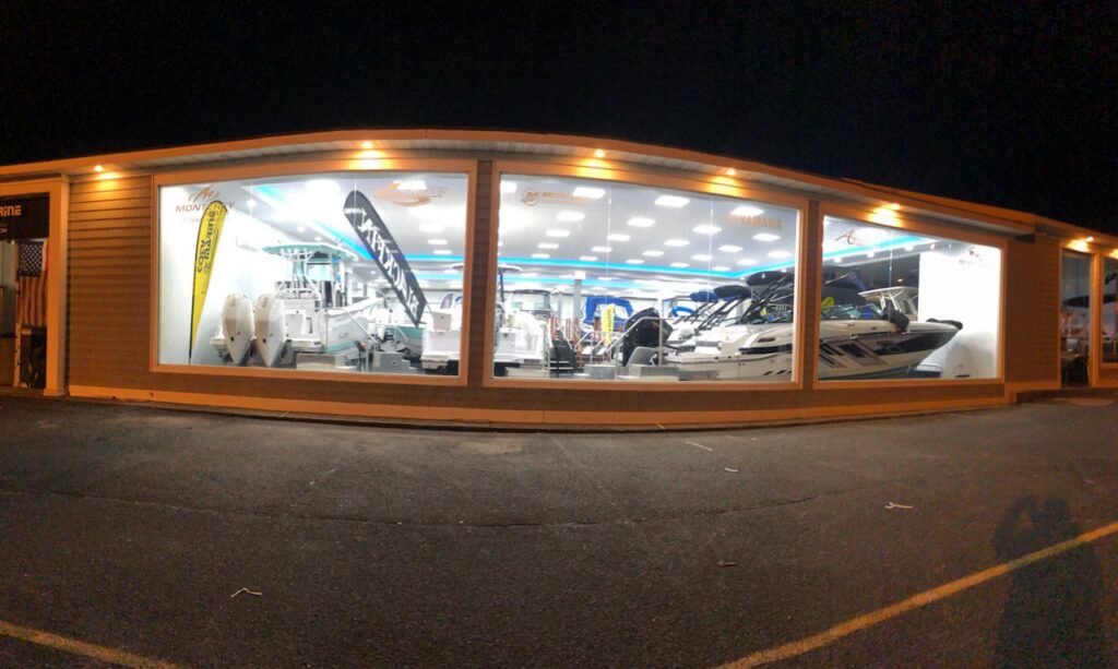Exterior view of a commercial showroom at night, showcasing bright interior lighting by RTF Electric LLC in Toms River, NJ.