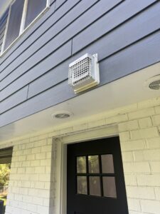 An exterior dryer vent on a residential home, serviced by Delta Clean Air in Boston, MA