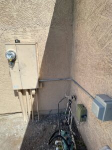 Exterior electrical conduit and junction boxes installed on a stucco wall by G5 Electric LLC in Phoenix, AZ