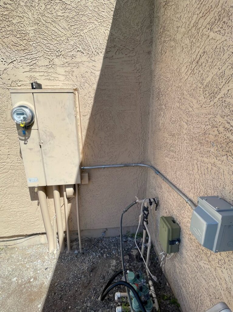 Exterior electrical conduit and junction boxes installed on a stucco wall by G5 Electric LLC in Phoenix, AZ