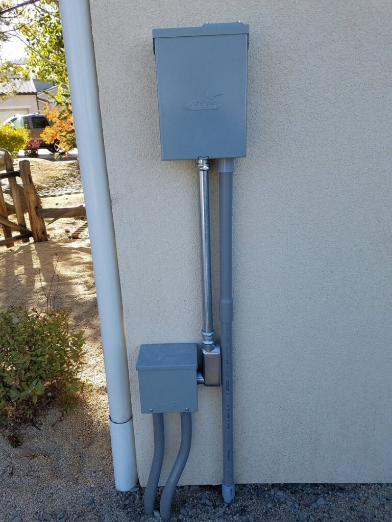 Exterior electrical conduit and junction boxes installed on a building wall by Jolt Electric in Salem, MA