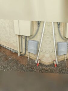 Exterior electrical conduit and junction boxes installed on a building by Sparks By Rabbit LLC in Scottsdale, AZ.