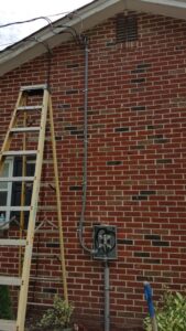 Exterior electrical conduit installation on a brick house by Gurley Electric LLC in Churchville, MD