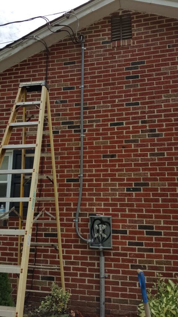 Exterior electrical conduit installation on a brick house by Gurley Electric LLC in Churchville, MD