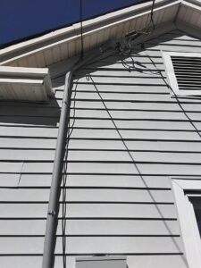Exterior electrical conduit neatly installed on the side of a house by Mister Sparky of Greensboro in Greensboro, NC.