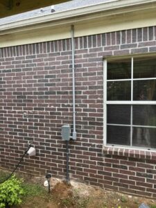 Exterior electrical conduit and box installation on a brick house by Spencer Electric in Hopkins, MN.