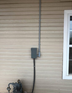 Exterior electrical conduit and a junction box installed on a building by Raschke & Sons Electric in Chattanooga, TN