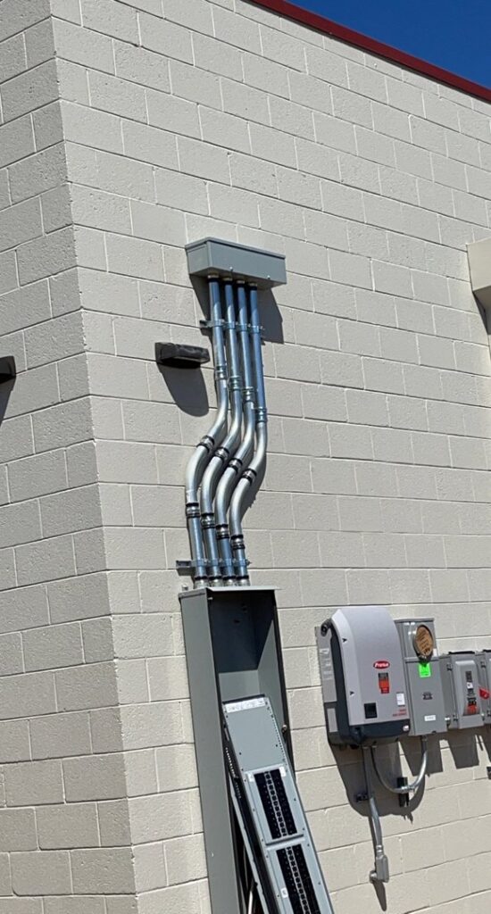 Exterior electrical conduit and a main service panel installed on a brick wall by G5 Electric LLC in Phoenix, AZ