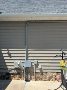 Exterior electrical conduits and wiring installed on the siding of a home, demonstrating work by Kaufman Electric in Greensboro, NC.