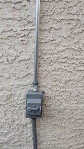 An exterior electrical conduit leading to a disconnect switch installed by Canyon Electric Company, Inc. in North Las Vegas, NV