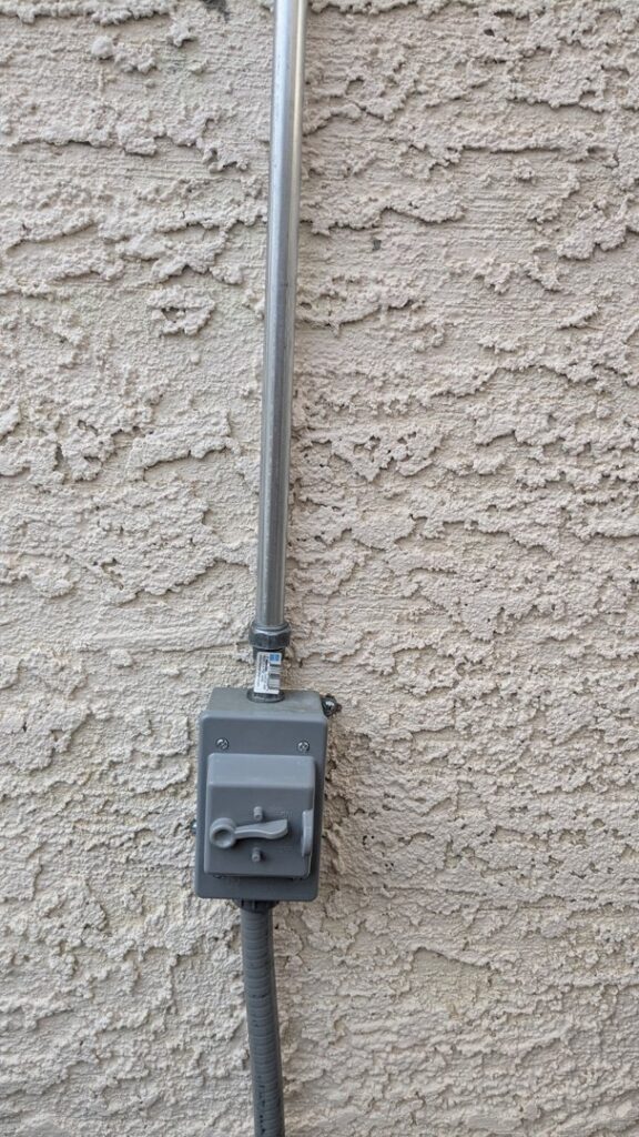 An exterior electrical conduit leading to a disconnect switch installed by Canyon Electric Company, Inc. in North Las Vegas, NV