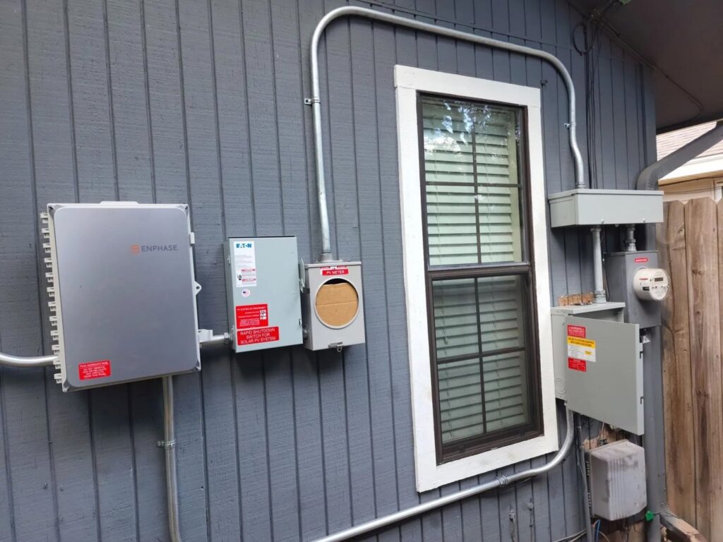 Exterior electrical installation with Enphase inverter and boxes by Omni Power Electrical Services LLC in San Antonio, TX
