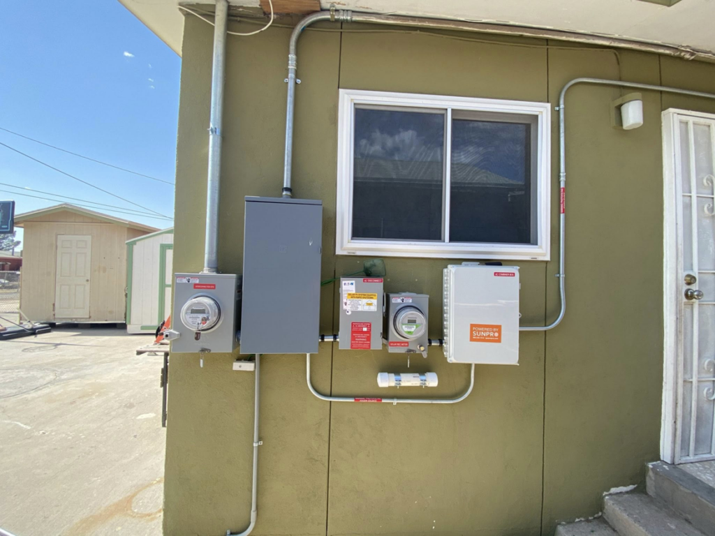 Exterior electrical installation with multiple meters and conduits on a building, completed by Flores power solutions in El Paso, TX.
