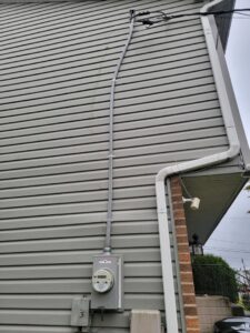 Exterior electrical meter and conduit installation on a residential building by The Dorky Electrician, LLC in Coplay, PA