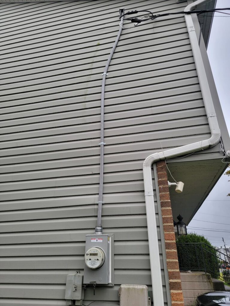 Exterior electrical meter and conduit installation on a residential building by The Dorky Electrician, LLC in Coplay, PA