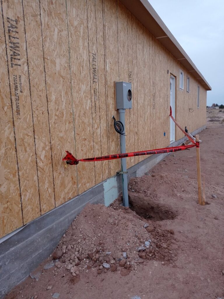 Exterior view of a new construction building showing an electrical meter box and conduit installed by The Specialist Electrical Contractor in Albuquerque, NM.