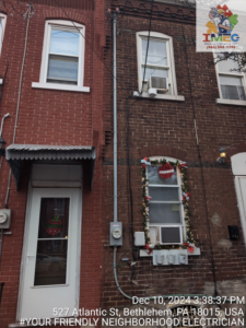 Exterior view of a brick building showing an electrical meter and conduit installed by Imecpower in Bethlehem, PA.