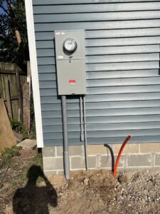An exterior electrical meter and conduit installation on a new siding wall by F&C Electrical Services LLC in Iowa City, IA.