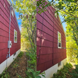 Exterior electrical meter and conduit on the side of a red house by Joey G Electric LLC in Waterbury, CT.