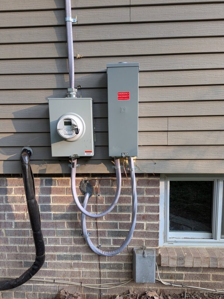 Exterior electrical meter and emergency disconnect box installed by Common Ground Electrical in Baltimore, MD.