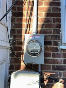 An exterior electrical meter installation on a brick wall completed by D&M Master Electric LLC in Newark, NJ.