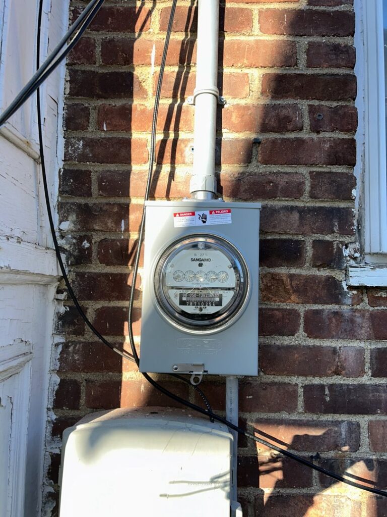 An exterior electrical meter installation on a brick wall completed by D&M Master Electric LLC in Newark, NJ.
