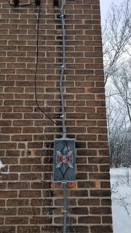 Exterior electrical meter and conduit installation by Detroit Speedy Electrician in Detroit, MI.