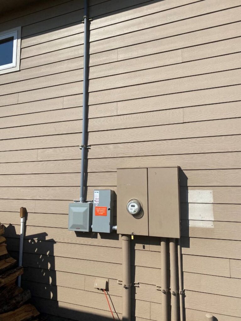 Exterior electrical meter and conduit installed on a residential building by J C Electric & Solar in Lewiston, ID