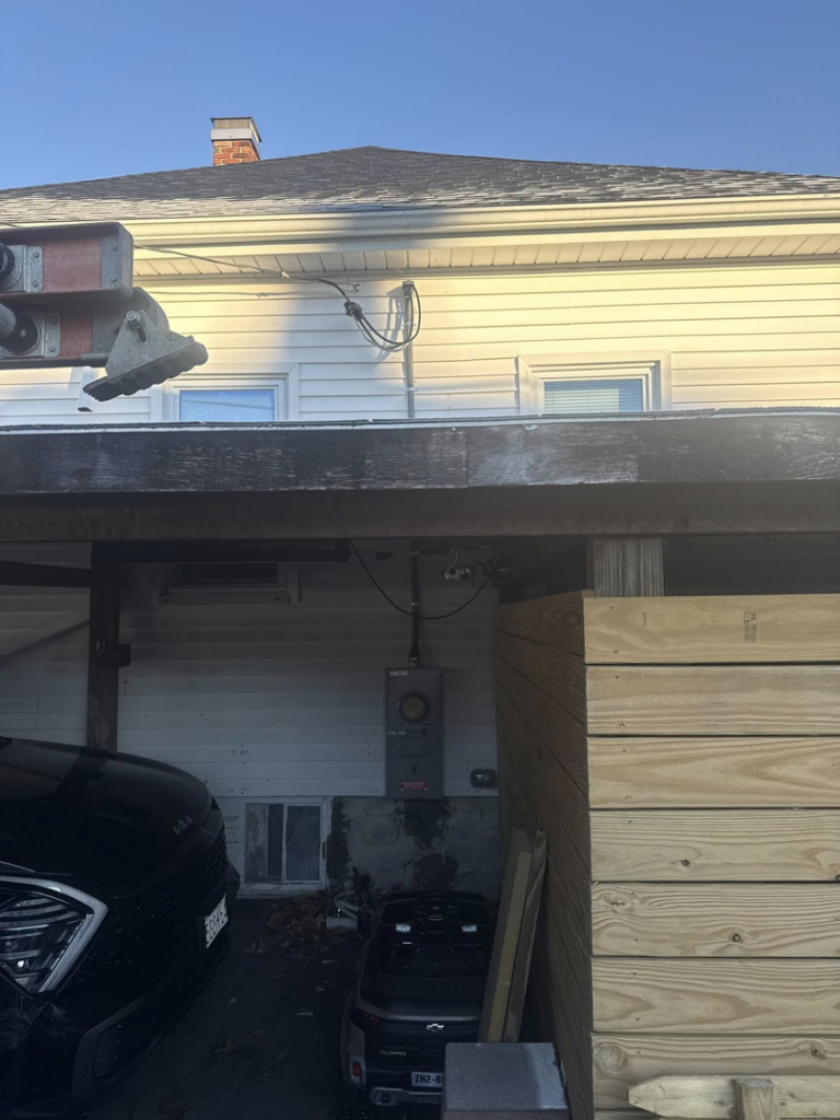 An exterior electrical meter and conduit installed on a house by Joshua Melendez Electrician LLC in New Bedford, MA.