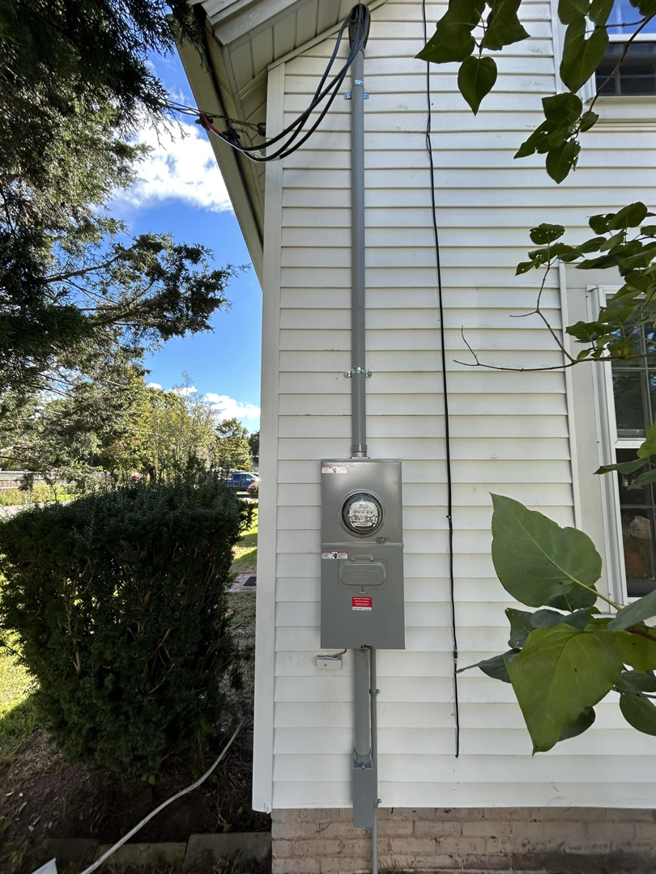 Exterior electrical meter and conduit installed on a home by KG Electric LLC in Cumberland, RI