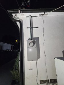 An exterior electrical meter and conduit installation on a residential building by Muse Electricians in Los Angeles, CA.
